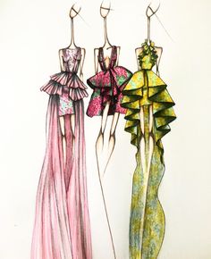 two dresses are hanging on clothes pins