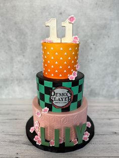 a three tiered cake decorated with flowers and the number 11