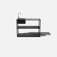 a black sink and shelf with a faucet in the middle, against a white background