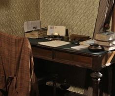 a desk with a chair and books on it