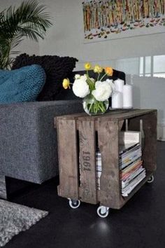 a living room with a couch, coffee table and flower arrangement on the end table