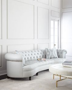 a living room with white walls and furniture