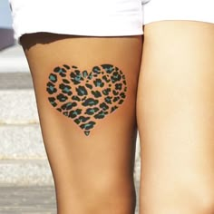 a woman's leg with a heart tattoo on it