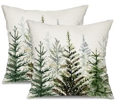 two white pillows with green trees on them