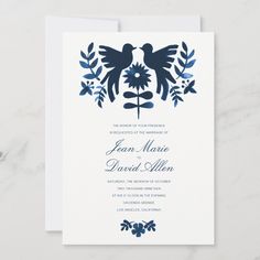 a wedding card with blue flowers and two birds on the front, surrounded by leaves