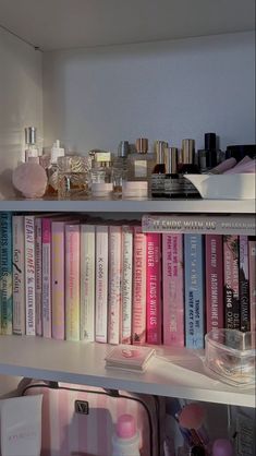 a book shelf filled with lots of different types of perfumes and bottles on top of it