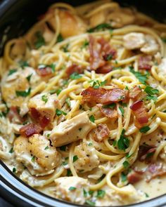 pasta with chicken, bacon and parsley in a crock pot ready to be eaten