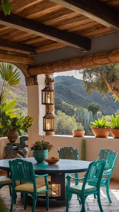 an outdoor table and chairs on a patio with mountains in the background