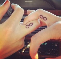 two people holding hands with tattoos on their fingers and the caption says, qusanc deviism, amma, sevilime can devenin can