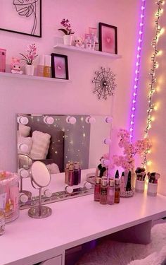 a white desk topped with a mirror and lots of lights