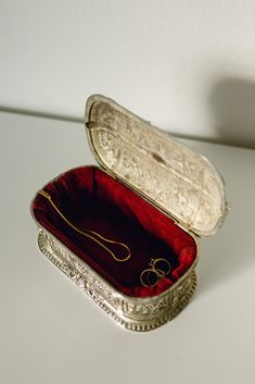 an open silver box on a white surface