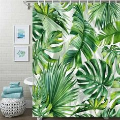 a shower curtain with green leaves on it