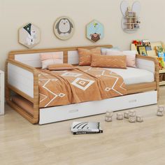 a bed sitting on top of a hard wood floor next to a book shelf filled with books