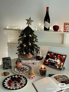 a small christmas tree sitting on top of a table next to a bottle of wine