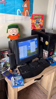 there is a computer on the desk with other toys and games in front of it