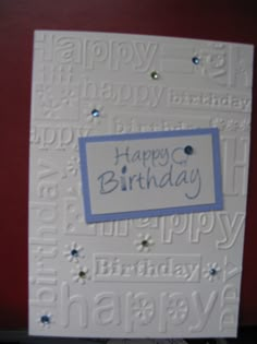 a birthday card with the words happy birthday written in blue and white on it's front