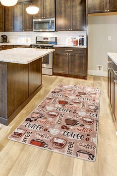 a kitchen with wooden cabinets and an area rug that has coffee related items on it