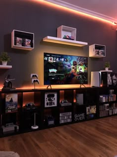 a living room with a large flat screen tv on top of a wooden entertainment center