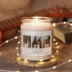 a candle is sitting on a table with string lights and a guitar in the background