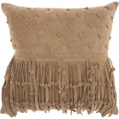 a brown pillow with fringes on it