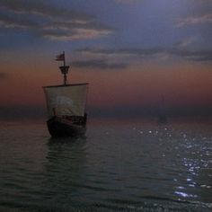 a boat floating on top of a body of water under a cloudy sky at night