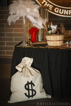 a table with a bag and other items on it next to a sign that says the gunpoint