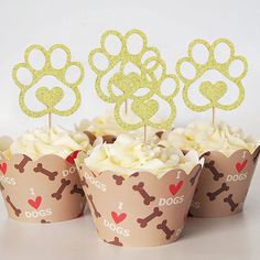 cupcakes with dog paw toppers in paper cups