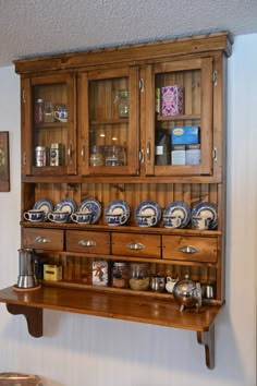 an old wooden cabinet with many plates on it