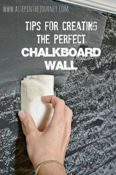 someone is cleaning the chalkboard with a sponge and cloth to clean it from dirt