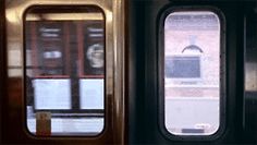 there are two doors on the train next to each other and one has a window