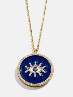 The 18K Gold Evil Eye Necklace is a reversible pendant piece, symbolizing protection. One side features a white evil eye surrounded by multicolored crystals on a navy blue background. The other features a white evil eye with a textured 18K gold plated sterling silver background. The charm is attached to a sleek gold chain. Choose a side according to your mood that day and wear again and again. White Evil Eye, Gold Evil Eye Necklace, Evil Eye Necklace Gold, Silver Background, Navy Blue Background, Evil Eye Necklace, That Day, Eye Necklace, Gold Texture