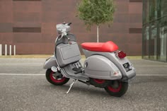 a silver and red scooter parked in front of a building