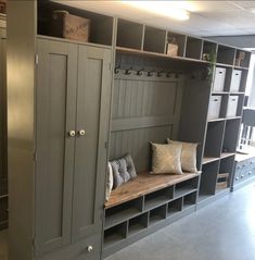 a room filled with lots of gray cabinets and shelves next to each other on either side of the wall