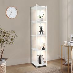 a tall white shelf with three shelves on each side and a clock mounted to the wall