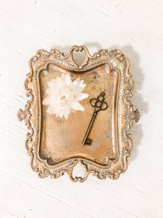 there is a key with a flower in it on the wall next to a mirror