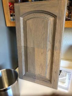 an unfinished cabinet door is shown in this kitchen