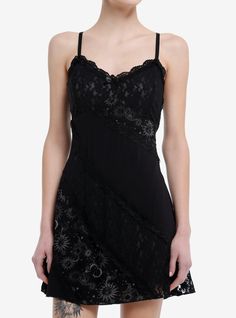 Bring that dark fairy energy into spring with this whimsical piece! This black dress comes with a built-in slip and features asymmetrical lace and celestial design panels. Complete with a dainty bow at the neckline  adjustable straps and a side zipper.100% rayonWash cold; dry flatLength: 33''ImportedListed in junior sizesModel is 5'10''Model wears size Small Dark Hippie Style, Goth Sundress, Gothic Dress Short, Hot Topic Aesthetic, Fairy Energy, Celestial Dress, Celestial Design, Lace Summer Dresses, Party Fits