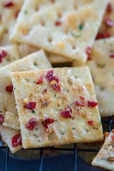 crackers with cranberries and cheese are on a cooling rack, ready to be eaten