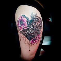 a woman's arm with a heart and flowers tattoo on the left side of her leg