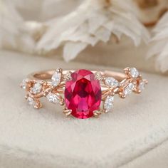 a close up of a ring with a pink stone and white diamonds on it,