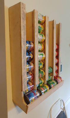 a wall mounted spice rack filled with cans