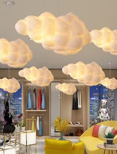 a living room filled with yellow furniture and lots of white clouds hanging from the ceiling