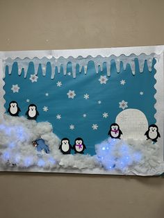 a bulletin board with penguins and snowflakes in the background, on a wall