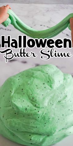 a cake with green frosting on it and the words halloween butter slime