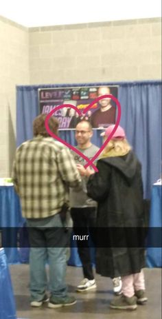 two people shaking hands in front of a heart - shaped sign that says murr