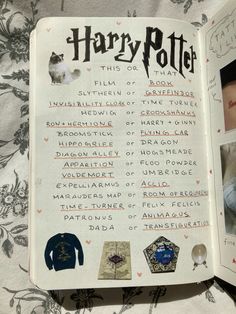 an open harry potter book with pictures on the page and other items in it,