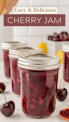 jars filled with cherries sitting on top of a counter