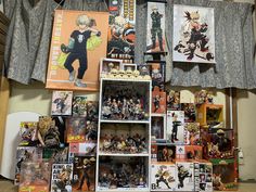 a bunch of anime action figures are on display in a room with curtains and drapes