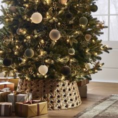 a decorated christmas tree with presents under it