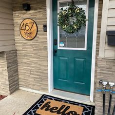 a welcome mat is placed in front of a door with a wreath on the side